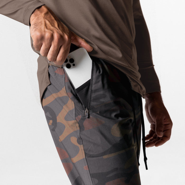 Tetra-Lite High Rib Jogger in rust camo worn by model holding white phone in pocket