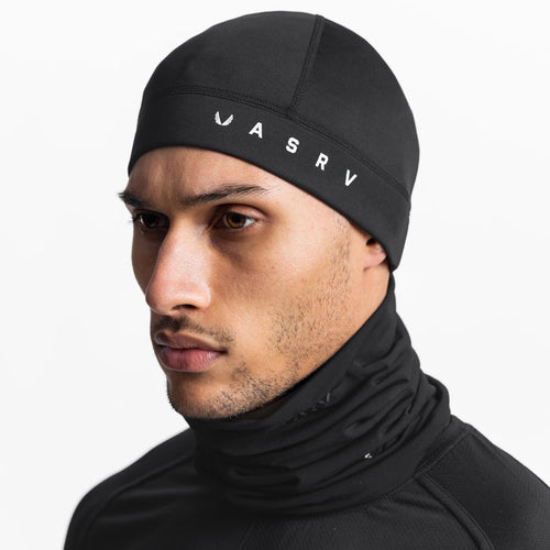 Performance Wings Logo Skull Cap in black, worn by model in profile view