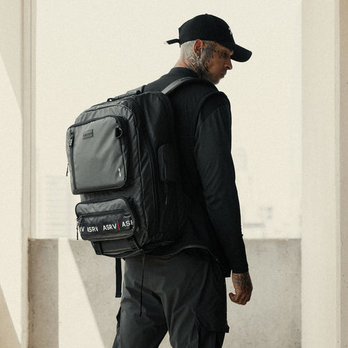 0580 Waterproof Large Travel Backpack in black, worn by model from back view