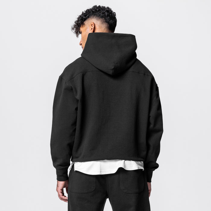 Black Tech-Terry™ Hoodie worn by model, back view, with white undershirt visible