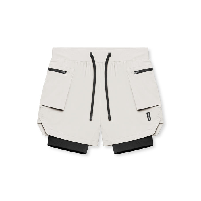 flatlay Tetra-Lite Liner Cargo Shorts in stone with black accents, top view