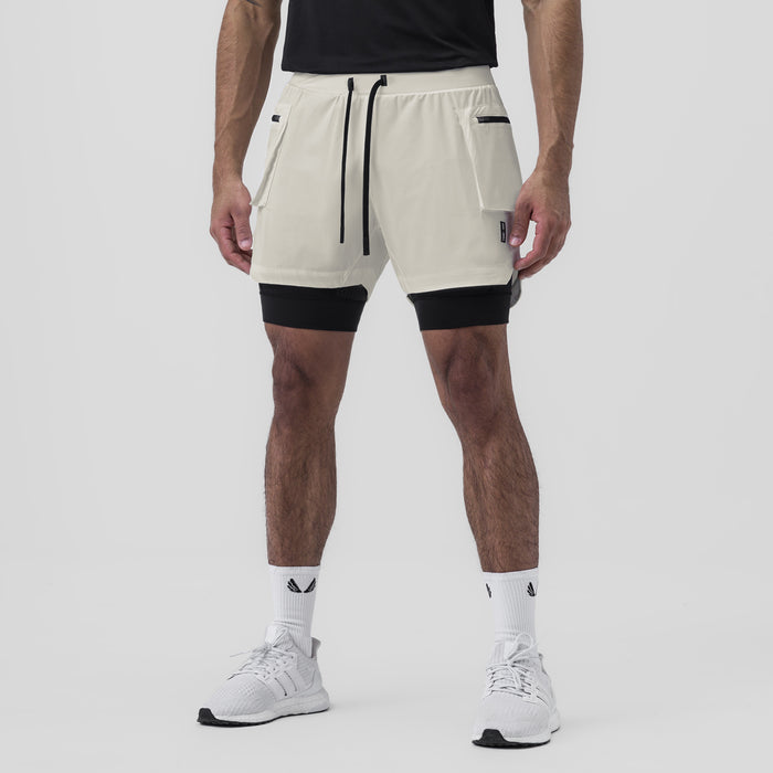 Tetra-Lite Liner Cargo Short in stone worn with black undershorts, front view on model