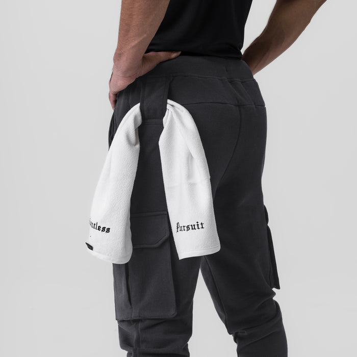 Tech-Terry Cargo High Rib Jogger in Dusk Black, worn by model with towel over shoulder, back view