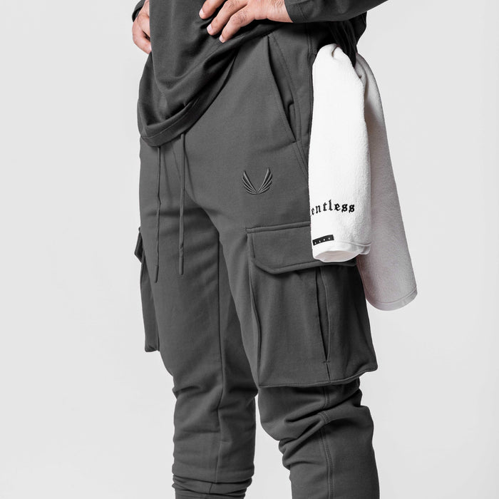 Tech-Terry Cargo High Rib Jogger in Space Grey worn by model, side view with towel
