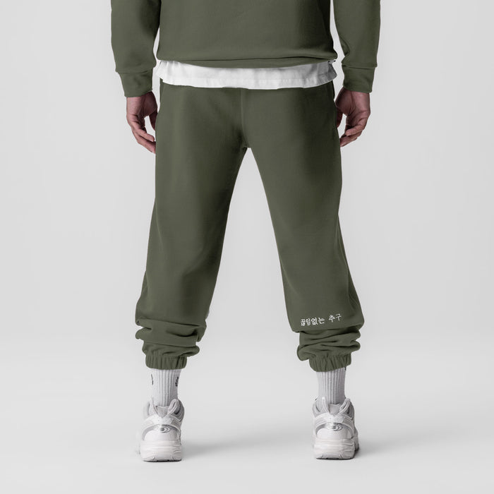 Tech-Terry Oversized Sweats joggers in olive, back view on model with white socks and sneakers