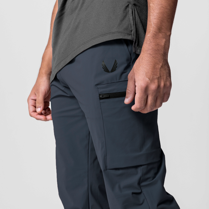 Tetra-Lite Standard Zip Jogger in navy worn by model, side view showing cargo pocket detail