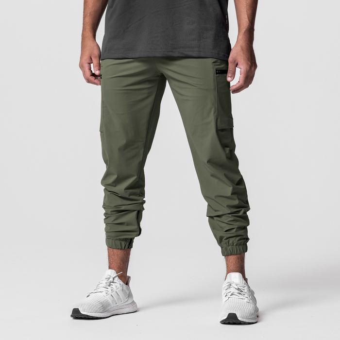 Tetra-Lite Standard Zip Jogger in olive, worn by model with white sneakers, front view