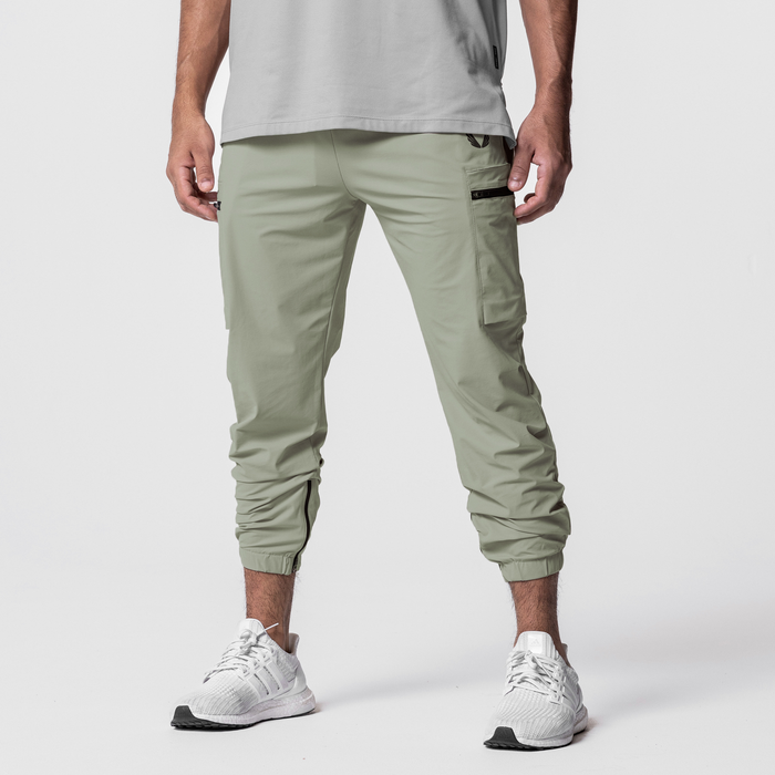 Tetra-Lite Standard Zip Jogger in sage, worn with white sneakers, front view