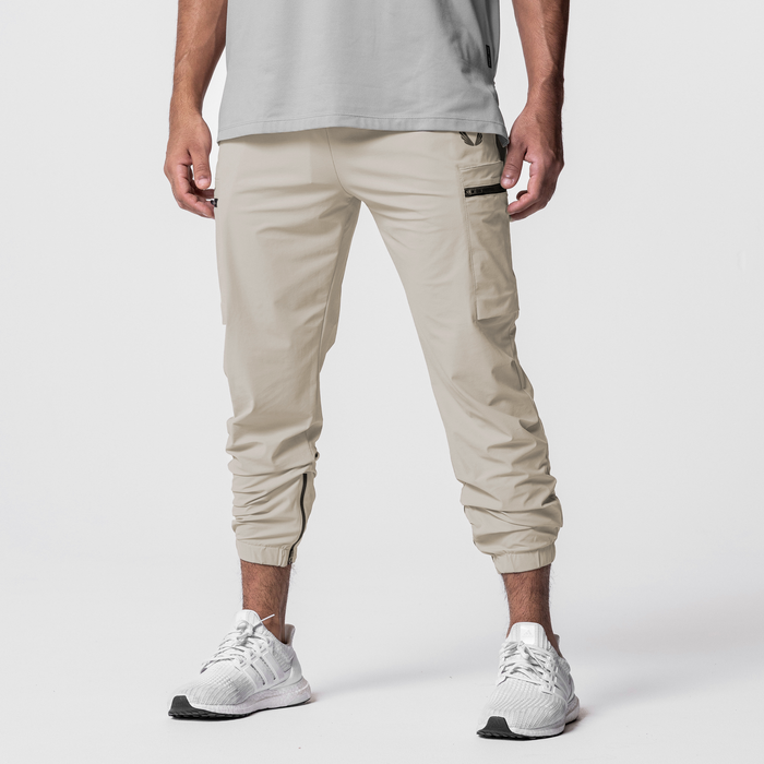 Tetra-Lite Standard Zip Jogger in sand, worn by model with white sneakers, front view