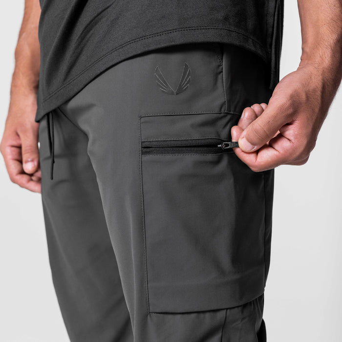 Tetra-Lite Standard Zip Jogger in Space Grey, model wearing joggers with hand on zippered pocket