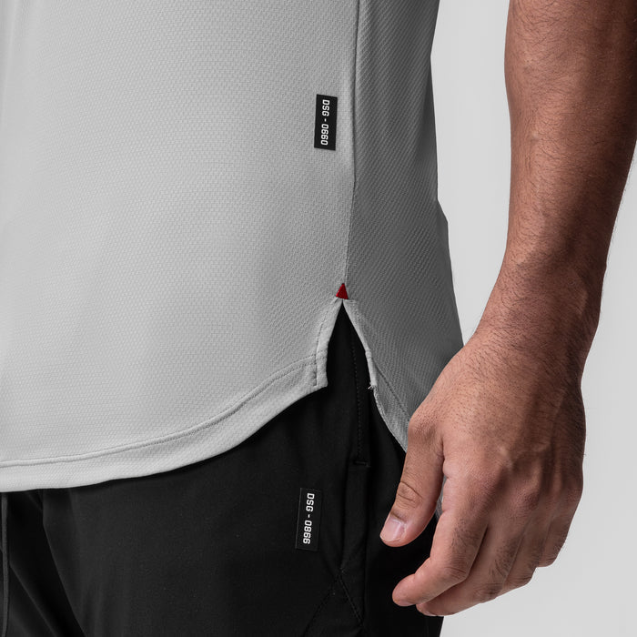 AeroSilver Established Tee in slate grey worn by model, side detail view showing hem and label