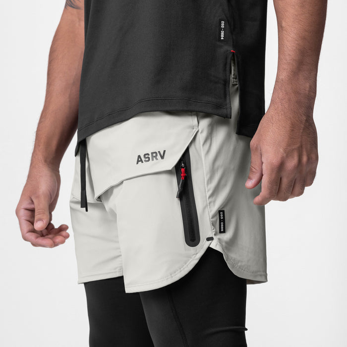 Tetra-Lite Tech Short in stone, worn by model showing side pockets and design details