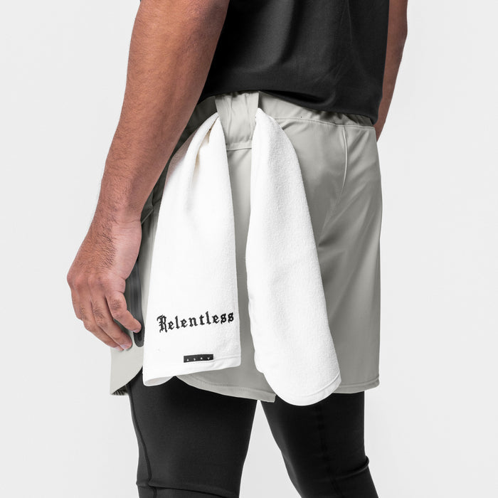 Tetra-Lite Tech Short in Stone, worn with white towel, side view