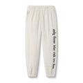 flatlay Sherpa Recovery Sweats joggers in ivory cream with black text on leg, front view