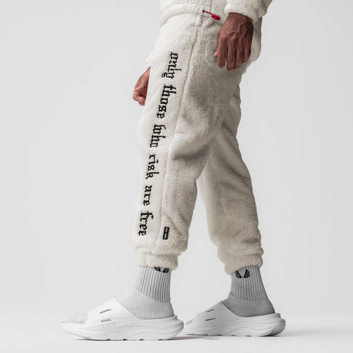 Sherpa Recovery Sweats in ivory cream worn by model, side view showing text down leg