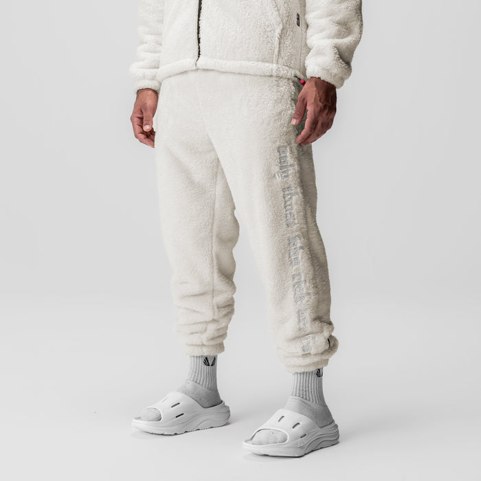 Sherpa Recovery Sweats in ivory cream worn by model, lower body view with white socks and sandals