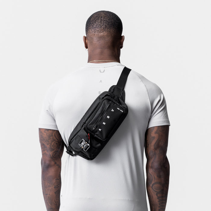 0703. Cordura® Tech Crossbody Pack in black, worn across chest, back view