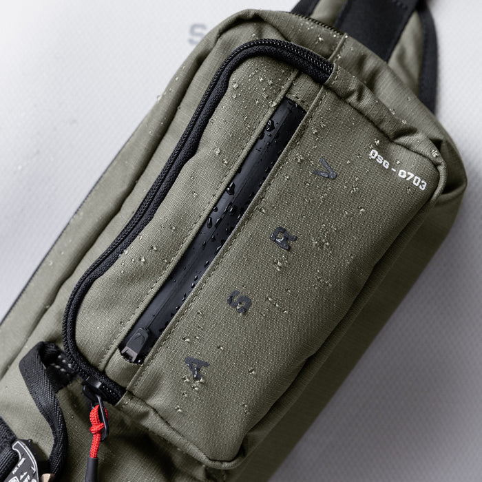 0703 Cordura Tech Crossbody Pack in olive, being worn/carried