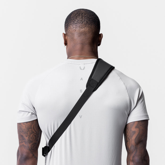 Waterproof Holster Sling Bag in black, worn across body on model from back view