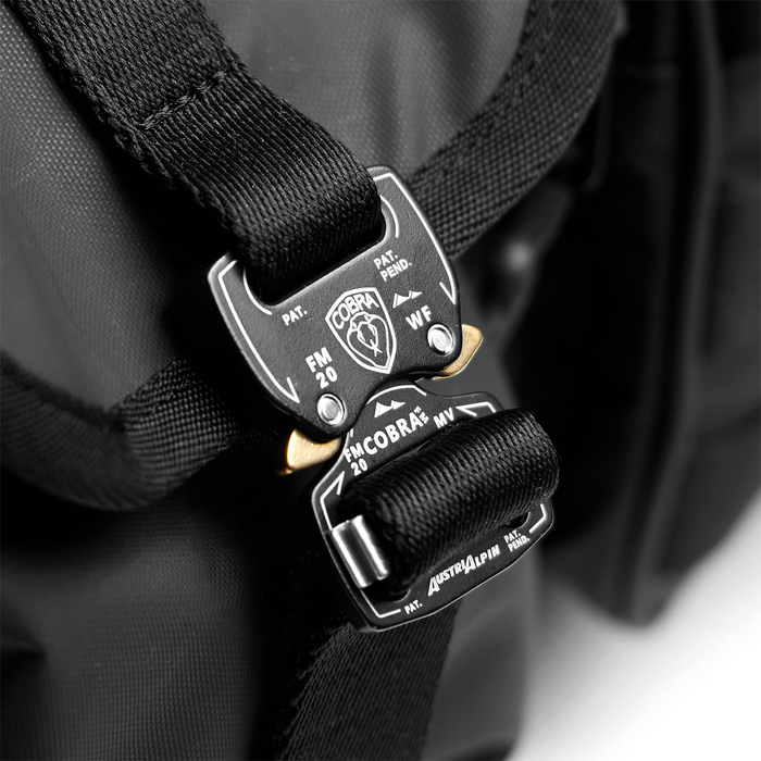 0710 Utility Gym Duffle Bag in black, worn on shoulder with tactical carabiner detail