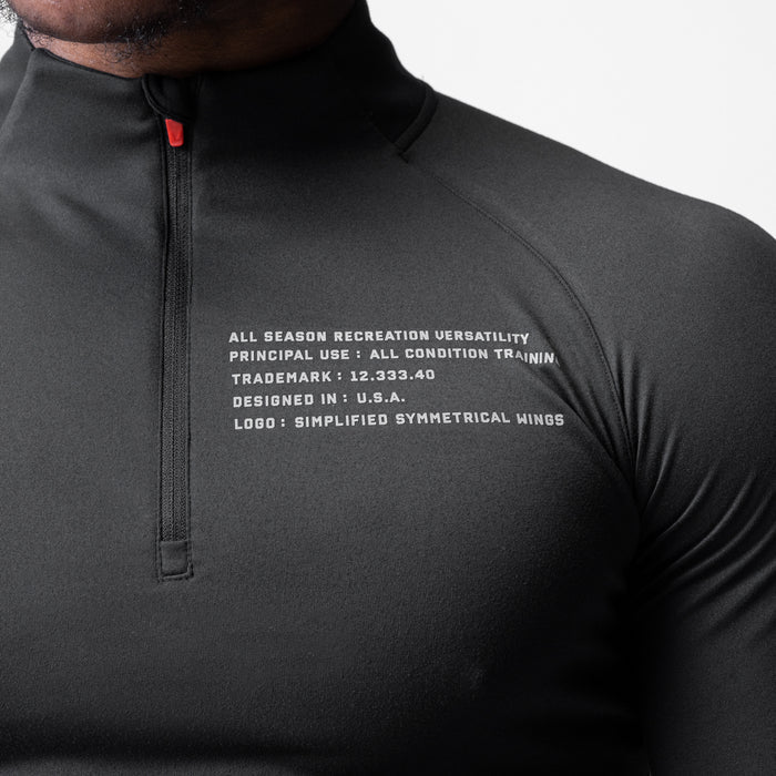 Core Fitted Quarter Zip in black worn by model, chest detail view showing text graphic