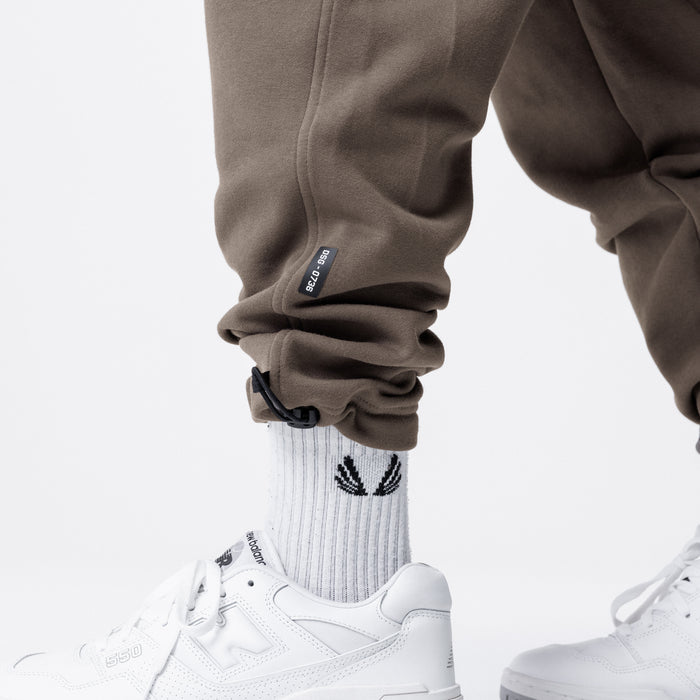Tech-Terry Cinch Cargo Jogger in deep taupe, worn with white socks and sneakers, lower body view