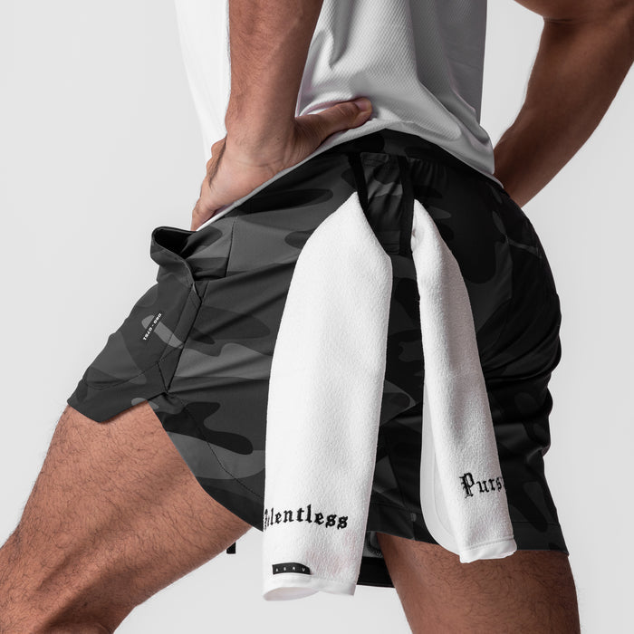 Tetra-Lite 5" Linerless Shorts in black camo, worn with white towel, side view