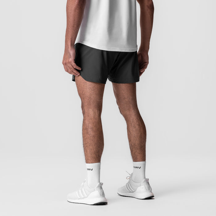 Tetra-Lite 5" Linerless Short in black, worn by model from behind, styled with white socks and sneakers