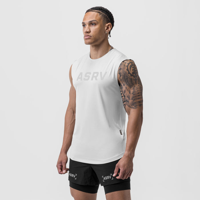 AeroSilver Cutoff Tank in white worn by male model with black shorts, side view