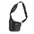 flatlay Water Bottle Holster Bag in black, front view with shoulder strap
