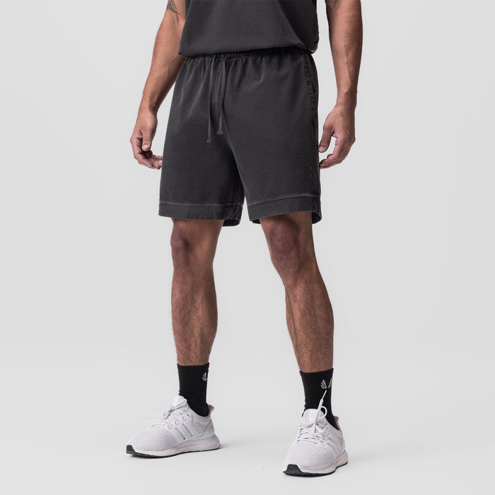 Tech Essential Sweat Short in faded grey worn by model with white sneakers and black socks