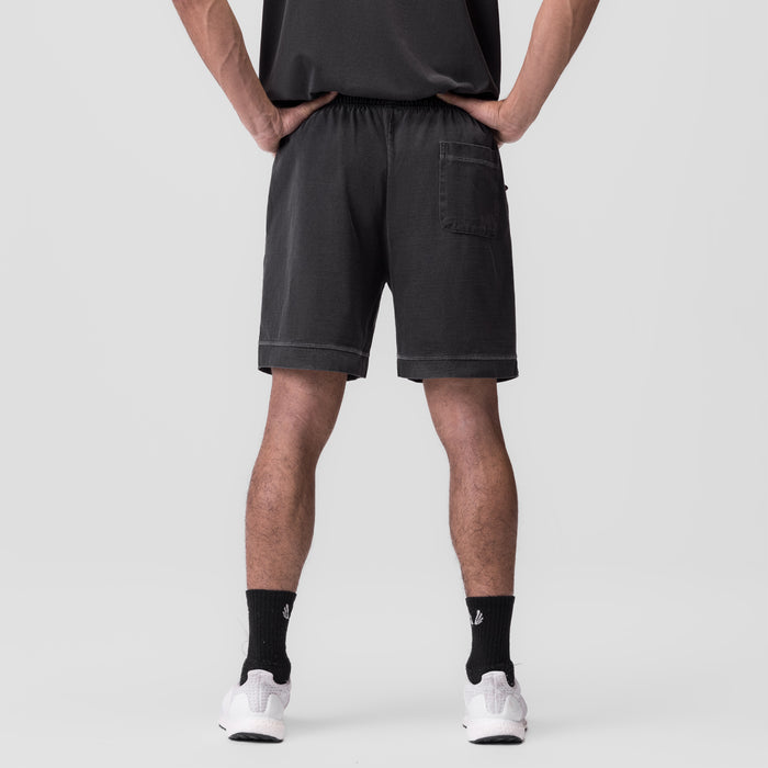 Tech Essential™ Sweat Short in faded grey, back view on model wearing black socks and white shoes