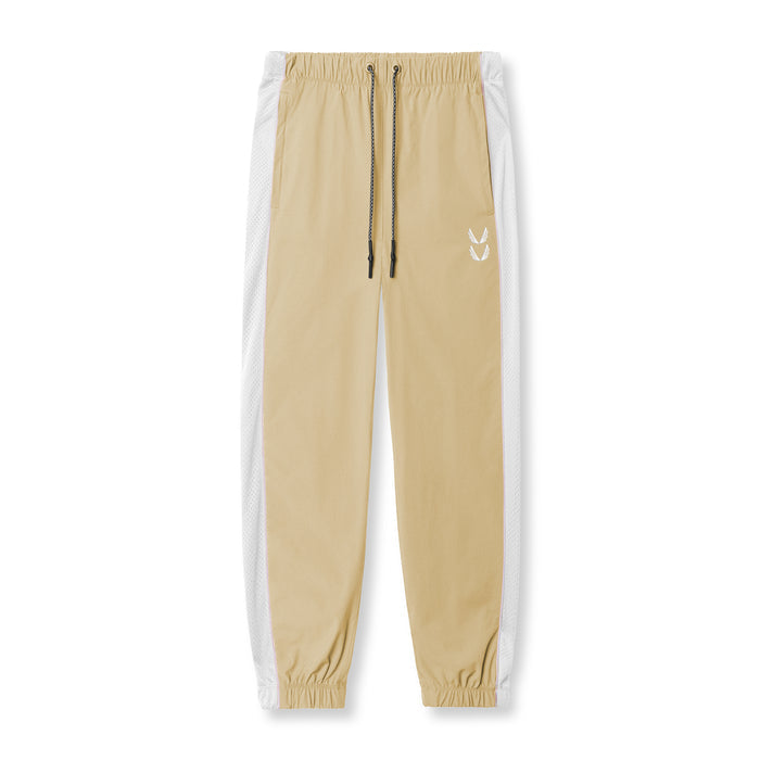 Flatlay of khaki ripstop oversized track pant with white side stripe, front view