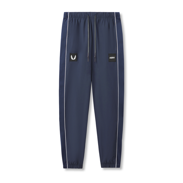 flatlay Ripstop Oversized Track Pant in navy with white piping, front view