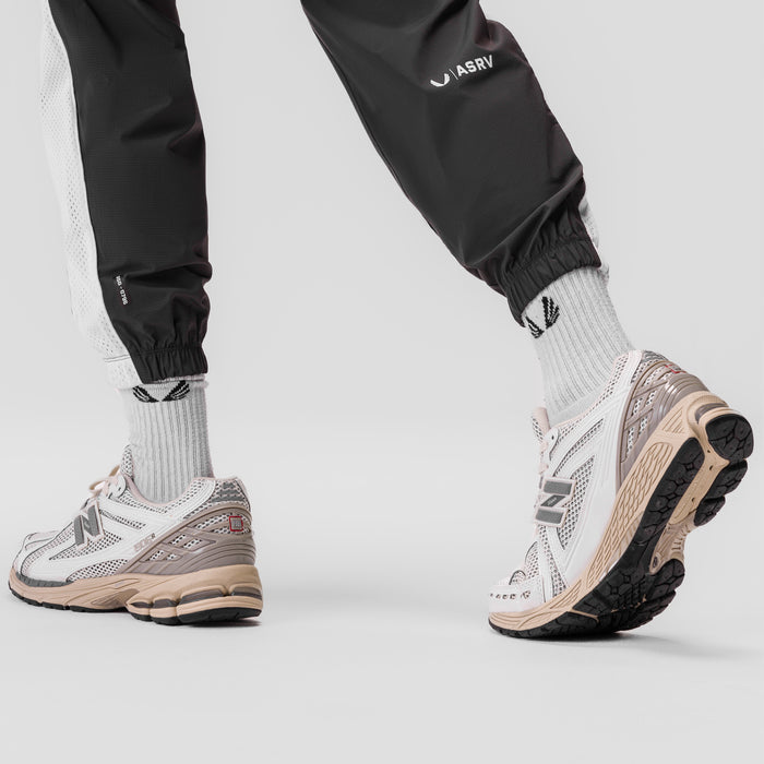 Ripstop Oversized Track Pant in Space Grey, worn with white socks and sneakers, front view