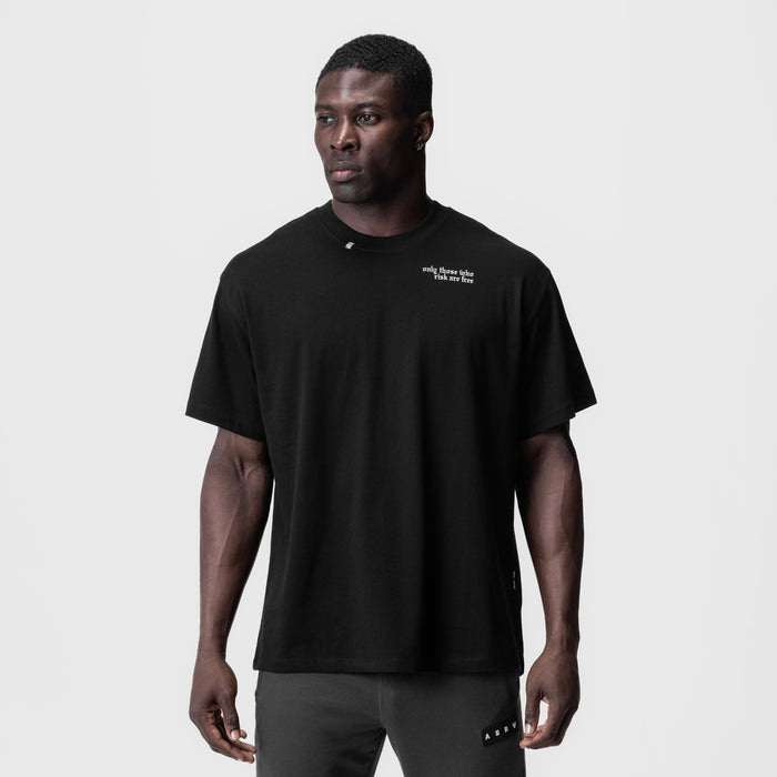 Black Tech Essential Relaxed Tee with 'Brush Wings' text, worn by model, front view