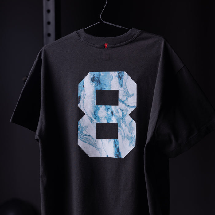 Black Tech Essential Relaxed Tee with blue marble number 8 graphic, back view on hanger