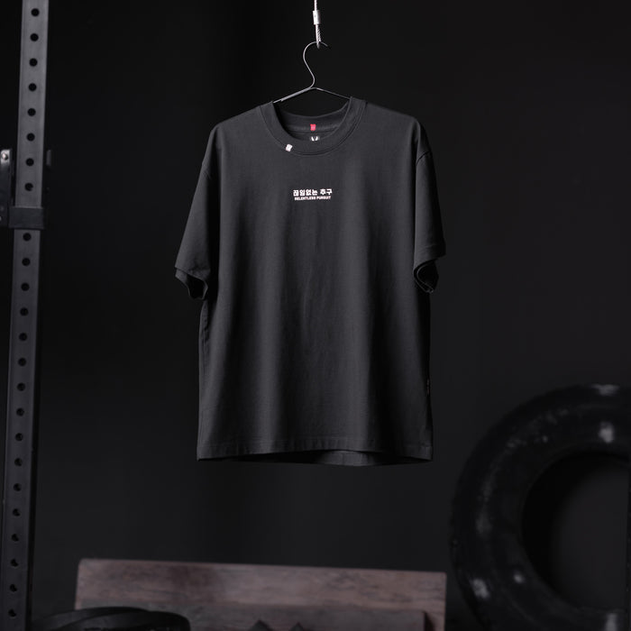 Tech Essential Relaxed Tee in black with RP Wings Stack graphic, displayed on hanger