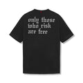 flatlay Tech Essential Relaxed Tee in black with white 'only those who risk are free' back graphic, front view