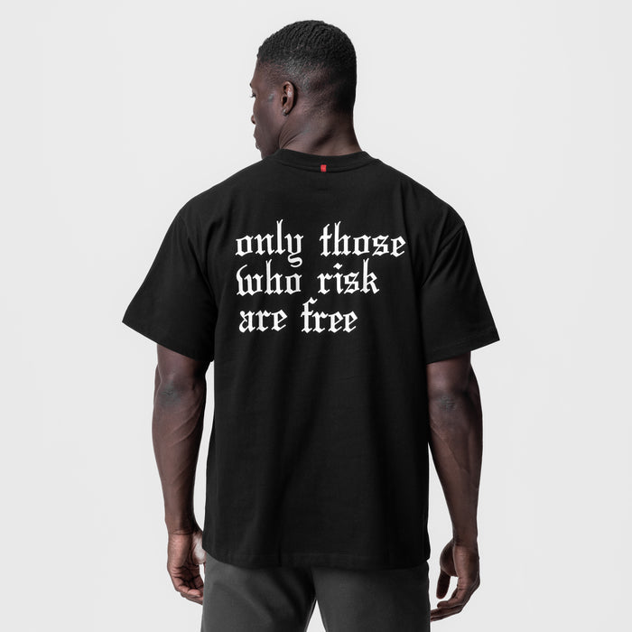 Black Tech Essential Relaxed Tee with 'only those who risk are free' text, back view on model