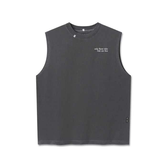 Flatlay of a dark gray sleeveless tank top with a crew neck, featuring "only those who risk are free" text on the left chest and a small black tag on the lower right hem, displayed on a clean white background.