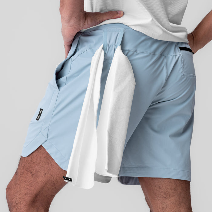 Tetra-Lite 7" Linerless Short in Light Sky, worn with towel over shoulder