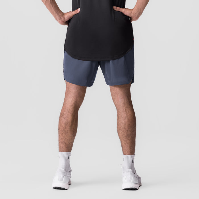 Tetra-Lite 7" Linerless Short in navy, modeled from front with hands on hips