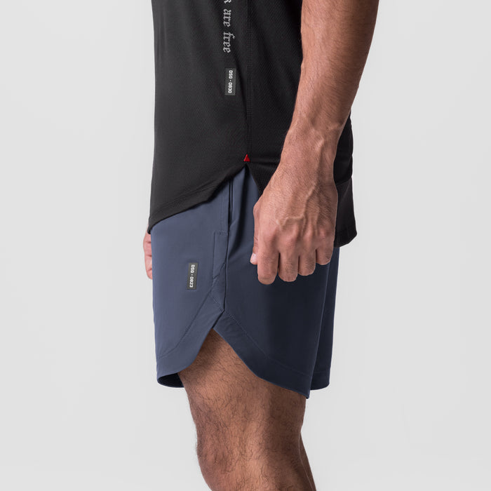 Navy Tetra-Lite 7" Linerless Short worn by model, side view