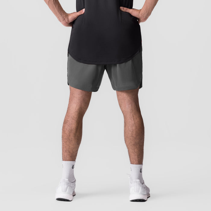 Tetra-Lite 7" Linerless Short in gray, worn by model with hands on hips, front view