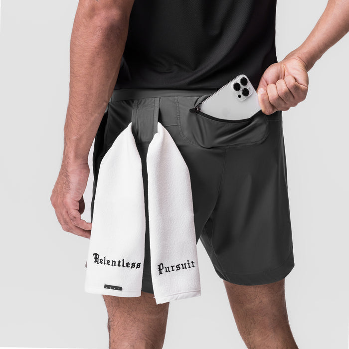 Tetra-Lite 7" Linerless Short in raven, worn with white towel, front pocket detail