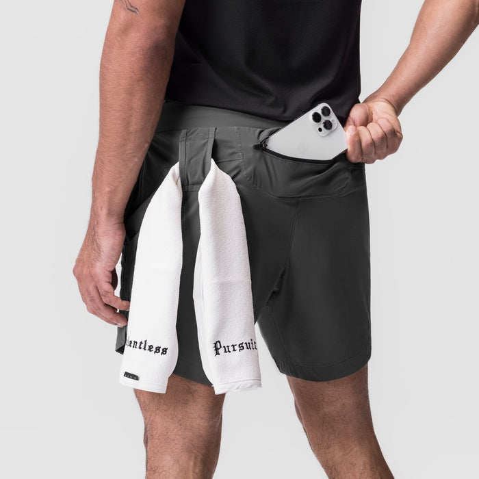 Tetra-Lite 7" Linerless Short in space grey, model holding phone and white towel