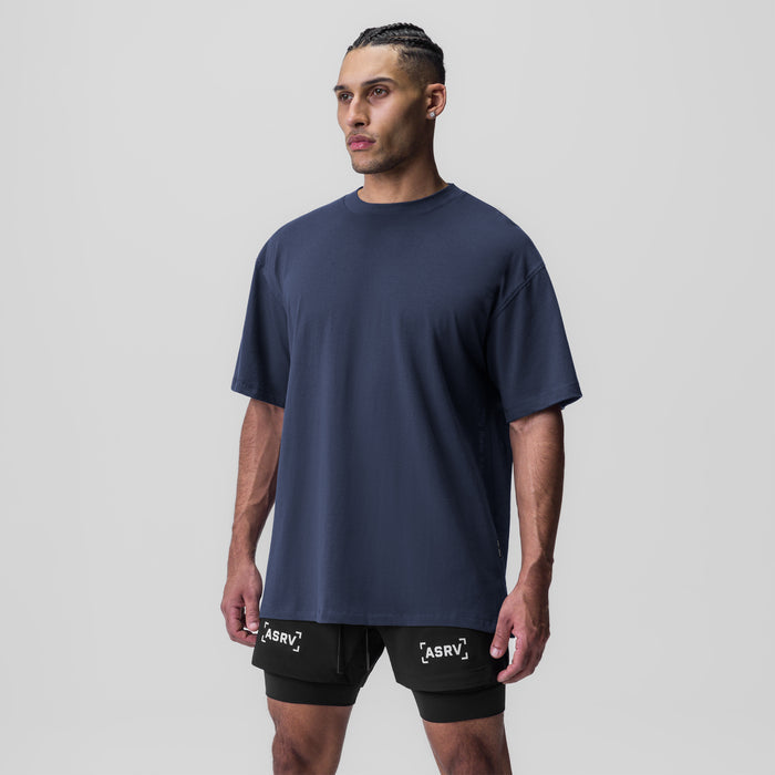 Navy oversized Supima tee worn with black shorts, front view on model