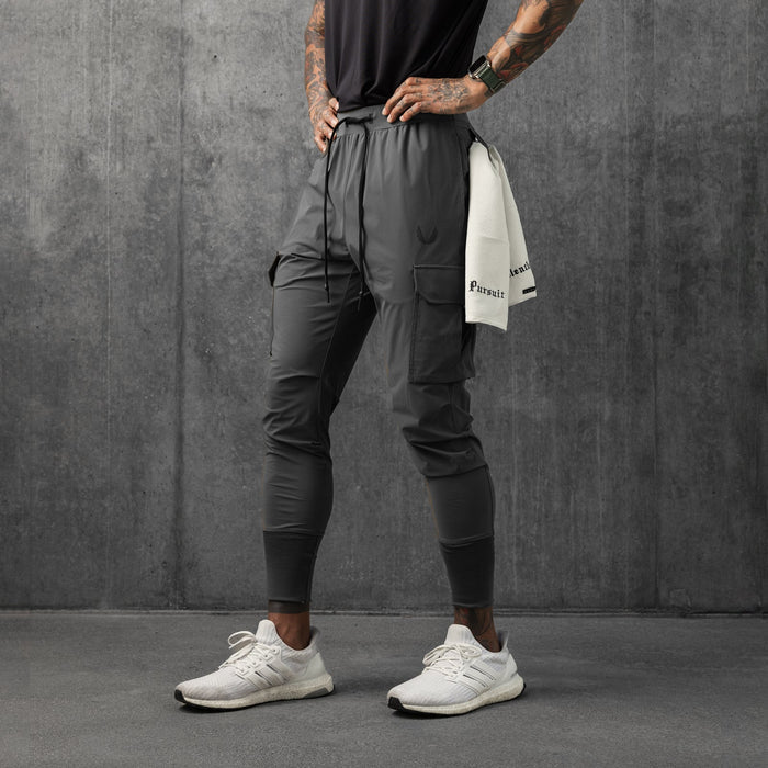 Tetra-Lite Cargo High Rib Jogger in space grey, worn by model standing against concrete wall