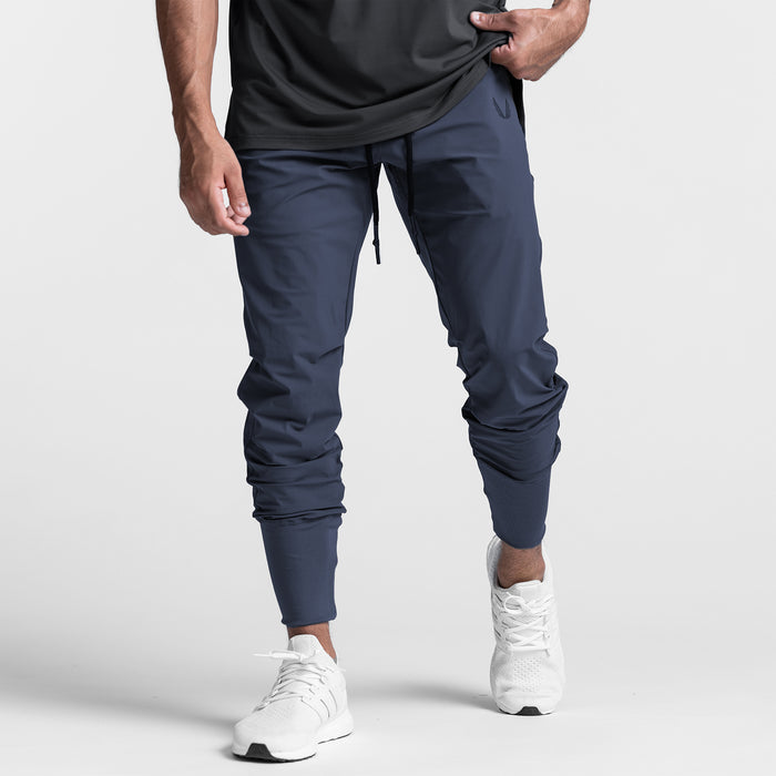Tetra-Lite High Rib Jogger in navy worn by model with white sneakers, front view